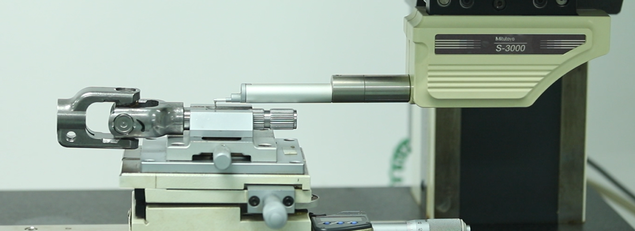 Precision measurement equipment inspecting a universal joint component